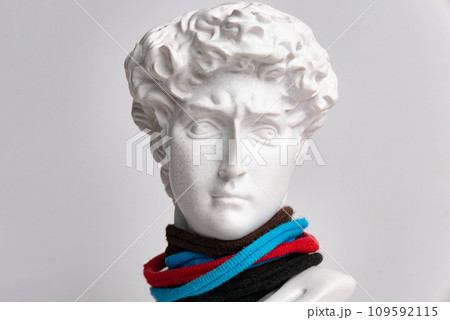 Statue. On a white isolated background. Gypsum statue of David's head. Man. 109592115