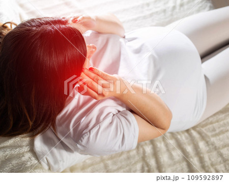 Headache and dizziness in a pregnant girl holding her head. Hormonal changes in pregnant women, symptom 109592897