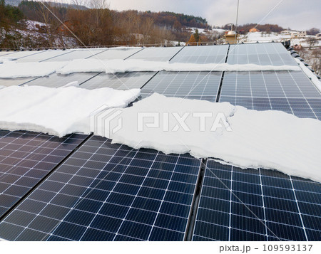 Roof solar panels with snow on top of them. Solar energy in winter. 109593137