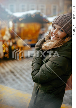 smiling modern 40 years old woman at winter fair in city 109593212