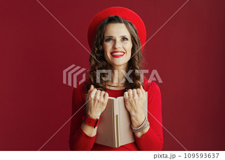 smiling elegant female against background with book smiling elegant female against background with book 109593637