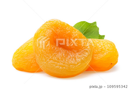 Pile of dried apricots with a leaf close-up on a white background. Isolated 109595342