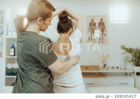massage therapist woman in massage cabinet doing checkup massage therapist woman in massage cabinet doing checkup 109595417