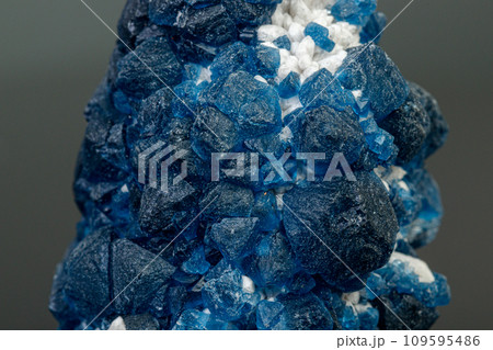 macro mineral stone Fluorite on quartz on a gray background macro mineral stone Fluorite on quartz on a gray background 109595486