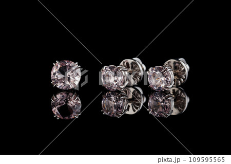 beautiful gold earrings with morganite gemstones on a black background 109595565