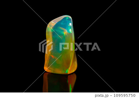 macro mineral stone rare and beautiful opals on a black background 109595750