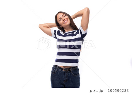close-up of a young brunette woman model dressed in a striped t-shirt and jeans. people lifestyle 109596288