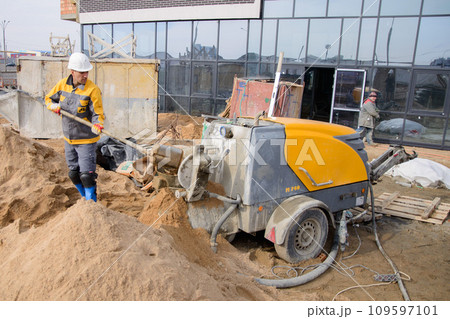 A builder in work clothes is doing his job A builder in work clothes is doing his job 109597101