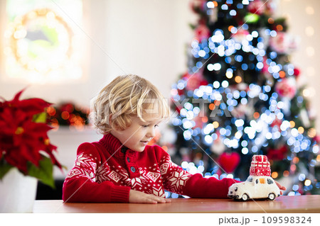Child with Christmas present. Kid with Xmas gift. 109598324