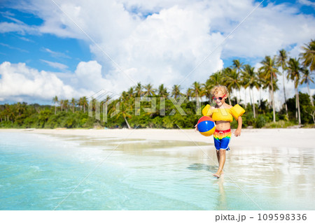 Kids play on tropical beach. Sand and water toy. 109598336