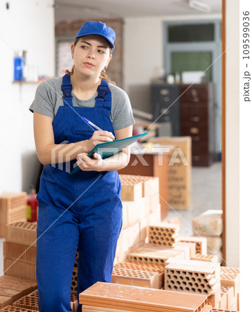 Female engineer matching check list during repair works 109599036