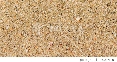A background of sand, small pebbles and flowing waves on the sea beach. Summer vacation and coastal nature concept 109601410