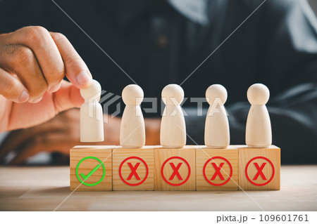Wooden block held by businessman hand displays a check mark representing an employment choice. Reflects business service rating and satisfaction concept. Think With Yes Or No Choice. 109601761