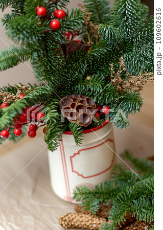 Homemade christmas decorations on table. Christmas bouquet in vase 109602616