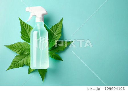 Spray bottle with cleaning product and green leaves around. Eco cleaning concept. Environmentally friendly bio natural cleaning products. Copy space Spray bottle with cleaning product and green leaves around. Eco cleaning concept. Environmentally friendly bio natural cleaning products. Copy space 109604108
