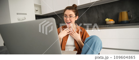 Work from home, remote job concept. Young woman sitting in kitchen, using laptop, joins video chat conversation, give online lessons, talking to client on computer 109604865