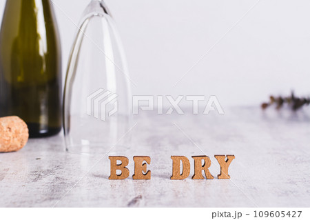 Sober January concept, text, glass, bottle and cork on the table Sober January concept, text, glass, bottle and cork on the table 109605427