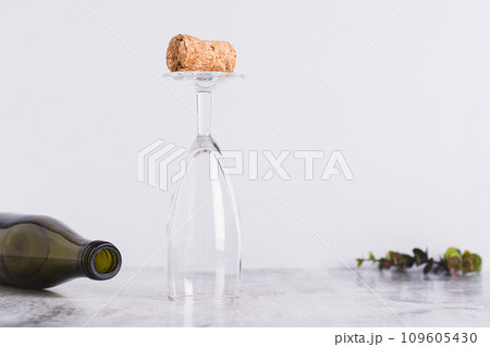 Sober January concept, cork on an inverted glass and bottle on the table 109605430
