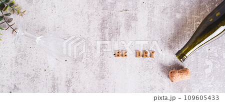 Sober January concept, text, glass and bottle on the table top view web banner Sober January concept, text, glass and bottle on the table top view web banner 109605433