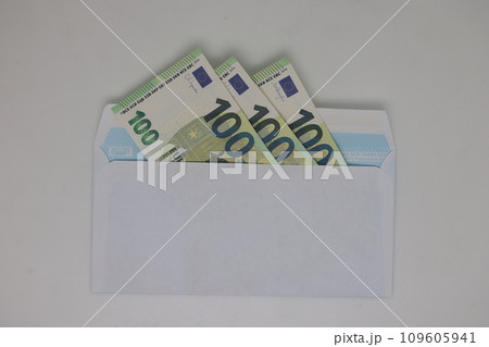 Toy house. banknotes in a yellow envelope on a light background. envelope with banknotes. close-up of an envelope with cash. international currency banknote. Euro dollars rubles. 109605941