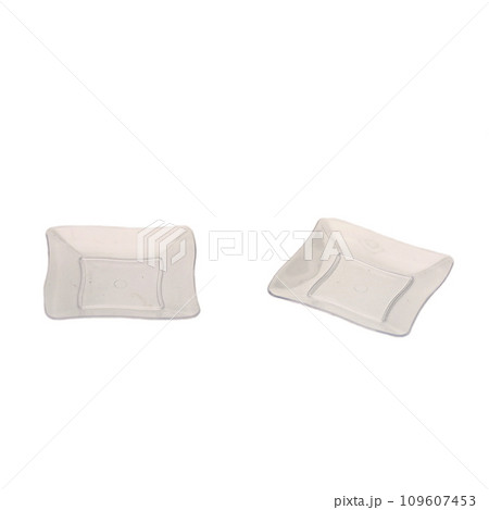 Two transparent plastic dessert plates isolated over white background Two transparent plastic dessert plates isolated over white background 109607453