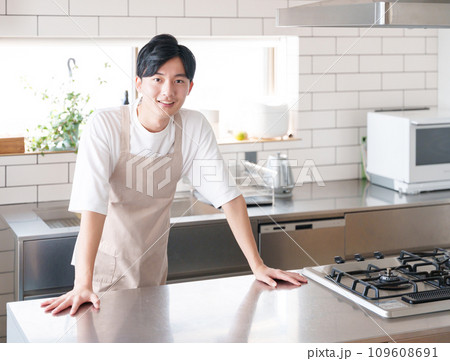 キッチンで料理する笑顔の男性 キッチンで料理する笑顔の男性 109608691
