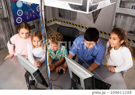 Enthusiastic children play in the quest room of inscrutable bunker 109611288