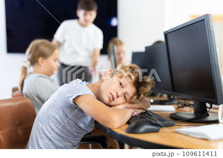 Boy student sleeps while sitting at computer 109611411