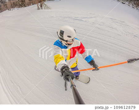 A daring man conquers snowy slopes with style, showcasing skill and thrill as he maneuvers on a snowboard, capturing the essence of winter adventure A daring man conquers snowy slopes with style, showcasing skill and thrill as he maneuvers on a snowboard, capturing the essence of winter adventure 109612879