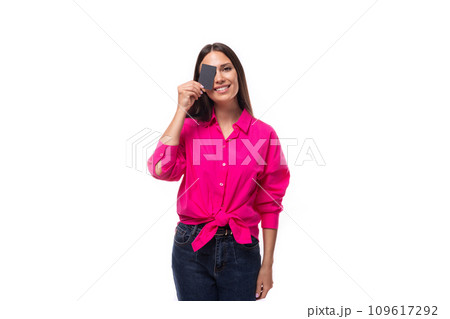 young cute caucasian brunette woman in pink shirt holding plastic card mockup young cute caucasian brunette woman in pink shirt holding plastic card mockup 109617292