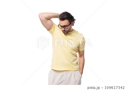 fashionable young successful European guy with stubble and mustache dressed in a light yellow T 109617342