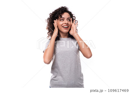 portrait of an authentic young european slim brunette woman with curly hair style on a white 109617469