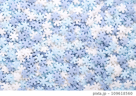 Snowflake shaped sugar sprinkles. Background of blue and white confetti candy, confectionery made of sugar and rice, consisting of flat multi colored candy sprinkles, used as sweet edible decoration. Snowflake shaped sugar sprinkles. Background of blue and white confetti candy, confectionery made of sugar and rice, consisting of flat multi colored candy sprinkles, used as sweet edible decoration. 109618560