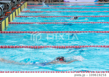 child swimmer swim in swimming pool. Water sports and competition, learning to swim classes for children. child swimmer swim in swimming pool. Water sports and competition, learning to swim classes for children. 109619258
