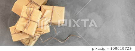 Christmas composition with gifts on dark textured background. Xmas greeting card with copy space. Christmas composition with gifts on dark textured background. Xmas greeting card with copy space. 109619722