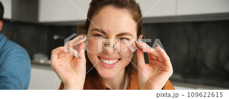 Close up portrait of attractive smiling woman with glasses, laughing and looking happy at camera 109622615