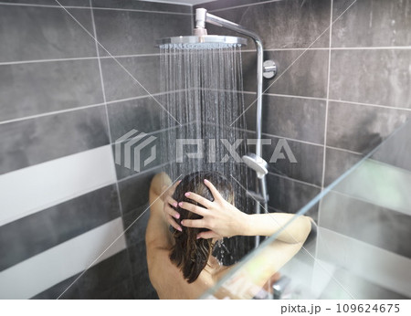 woman takes cool shower and washes hair woman takes cool shower and washes hair 109624675