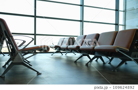 Empty brown leather chairs in airport lounge Empty brown leather chairs in airport lounge 109624892