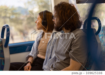 Handsome tourist couple is travel together while riding in public bus and looking at window Handsome tourist couple is travel together while riding in public bus and looking at window 109625108