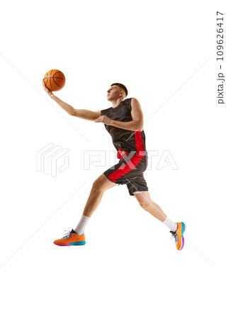 Slum dunk. Winner. Young guy, basketball player in motion, practicing, playing isolated over white background. Sport concept 109626417