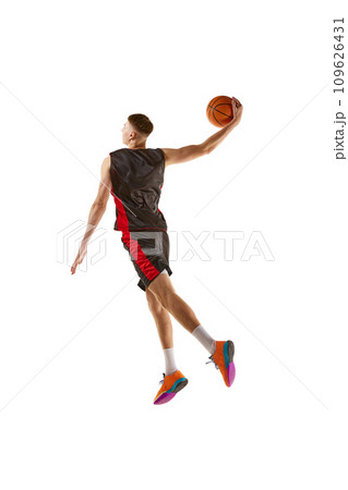Full-length dynamic image of young man, basketball player practicing, playing isolated over white background. Sport concept Full-length dynamic image of young man, basketball player practicing, playing isolated over white background. Sport concept 109626431