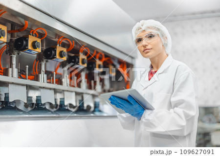 portrait happy women worker working in water plant factory clean hygiene process in bottling drinking water machine line. portrait happy women worker working in water plant factory clean hygiene process in bottling drinking water machine line. 109627091