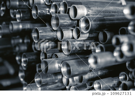 Metal pipes connector tubes. Construction cylindrical steel pipe stacked valious size in construction equipment store shelf. Metal pipes connector tubes. Construction cylindrical steel pipe stacked valious size in construction equipment store shelf. 109627131