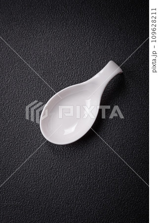 Beautiful empty white ceramic gravy boat on a textured concrete background 109628211