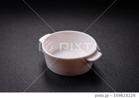 Beautiful empty white ceramic gravy boat on a textured concrete background 109628226