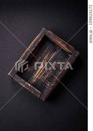 Empty rectangular wooden cutlery box on textured concrete background Empty rectangular wooden cutlery box on textured concrete background 109628272