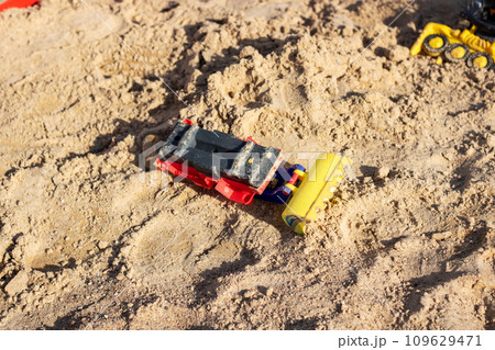 Children's toy car in the sand closeup Children's toy car in the sand closeup 109629471