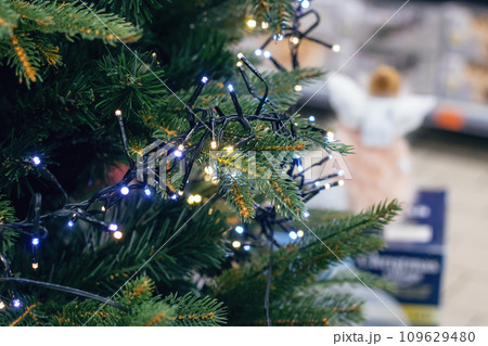 New Year's decorations on green spruce branches New Year's decorations on green spruce branches 109629480