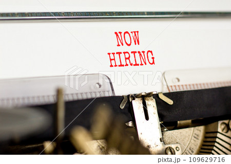 Now hiring symbol. Concept words Now hiring typed on beautiful old retro typewriter. Beautiful white paper background. Business marketing, motivational now hiring concept. Copy space. 109629716