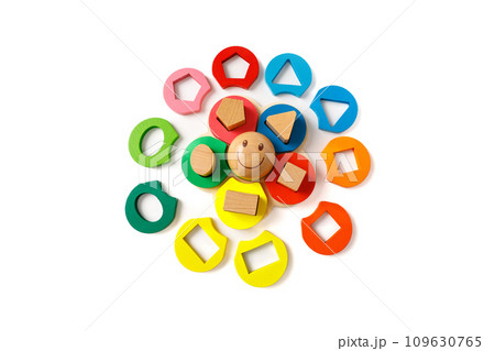 Wooden children's puzzle toy with colorful blocks of different shapes in form of funny sun, isolated on white background Wooden children's puzzle toy with colorful blocks of different shapes in form of funny sun, isolated on white background 109630765
